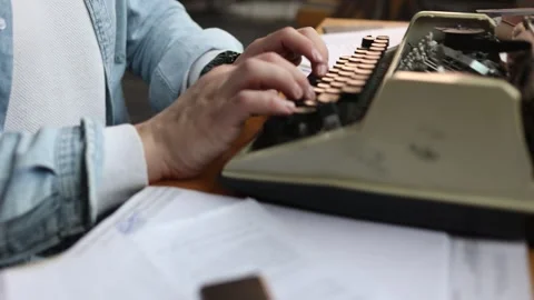 Soft-focused image of a writer struggling with creativity at his cluttered desk, Stock Footage 308410275
