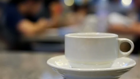 Soft focused steaming hot tea or coffee in a cup in a restaurant Stock Footage 95060525