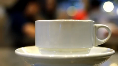Soft focused steaming hot tea or coffee in a cup in a restaurant Stock Footage