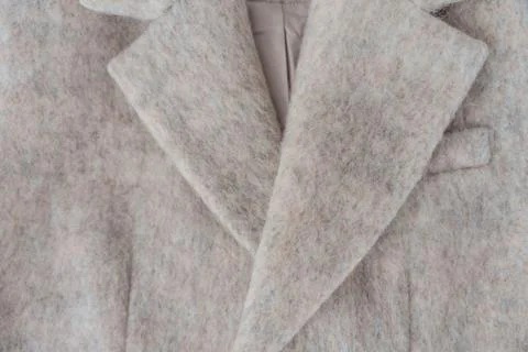 Soft fuzzy wool-blend coat lapel closeup showing tailoring detail and warm Stock Photos