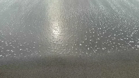 Soft gently waves sweeping across the sand beach Video stock 172210174