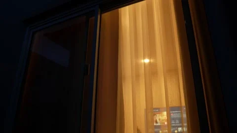 The soft glow of lights at dusk reflects household electricity use. Stock Footage 315449986