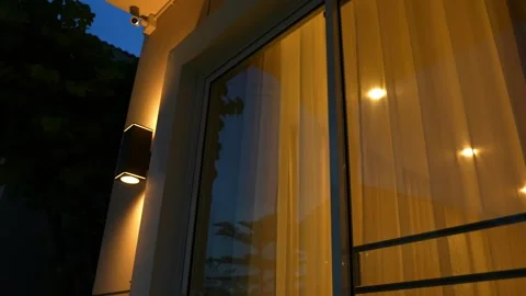 The soft glow of lights at dusk reflects household electricity use. Stock Footage 315450046