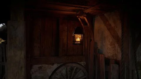 Soft glow of an old lantern illuminating rustic wooden barn at dusk Stock Illustration