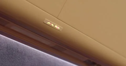 Soft glow over seating area. Gentle amber light bathes cabin interior 库存影片 333876862