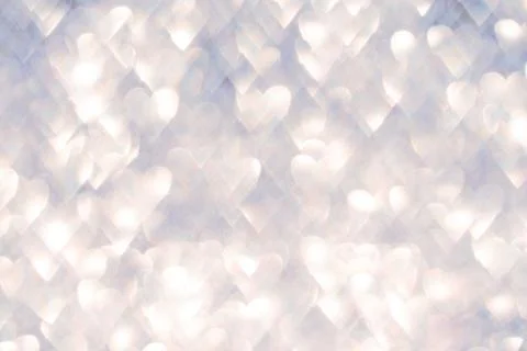 Soft glowing bokeh effect with heart shapes creating a dreamy background Stock Photos