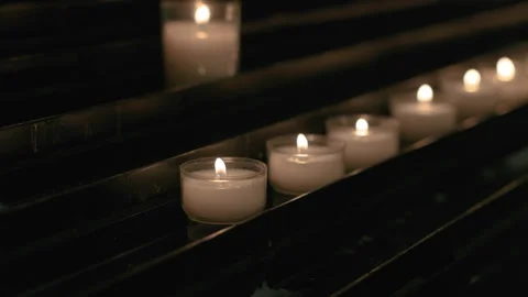 Soft Glowing Candles Lighting Calm Church Interior in Spiritual Setting Stock Footage 322551297