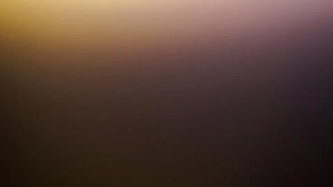 Soft glowing golden light blends into a deep purple gradient for a dreamy moo Stock Photos