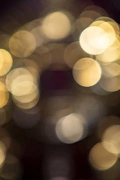 Soft glowing orbs create a dreamy atmosphere in a warm setting during evening Stock Photos