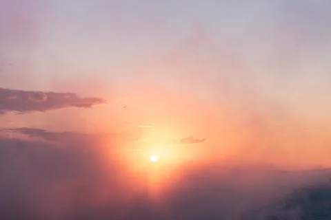Soft, glowing sunset behind thin clouds Stock Photos