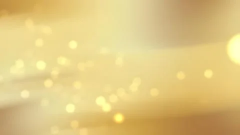 Soft golden bokeh background with subtle light effects. Stock Photos
