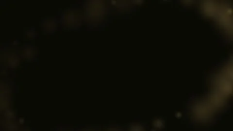 A soft golden bokeh light effect framing the edges of a dark black background Stock-Footage 335117838