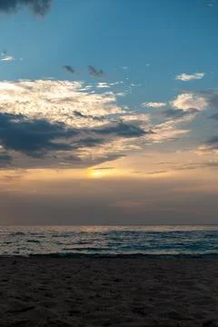 Soft golden light illuminates an empty sandy beach and the calm Black Sea Foto stock