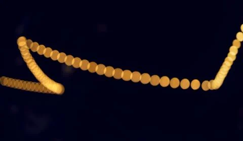 Soft golden lights appear as a gently curved line of blurred bokeh circles on Stock Illustration