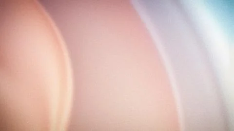 A soft, grainy 4K background with smooth transitions of pink, beige, and bl.. Stock Illustration