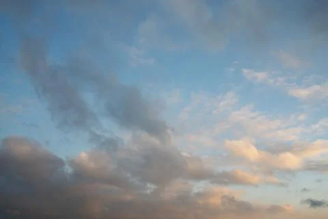 Soft Gray and Pink Clouds in Blue Evening Sky Stock Photos