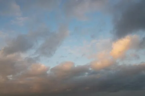 Soft Gray and Pink Clouds in Blue Evening Sky Stock Photos