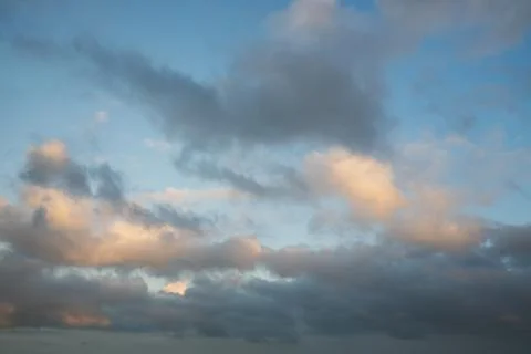 Soft Gray and Pink Clouds in Blue Evening Sky Stock Photos