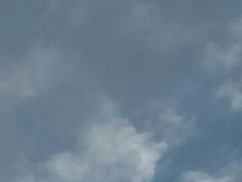 Soft Gray Clouds Drifting Across Blue Sky Stock Photos