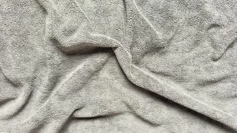 Soft gray terry cloth texture with elegant folds creating serene neutral, bac Stock Photos
