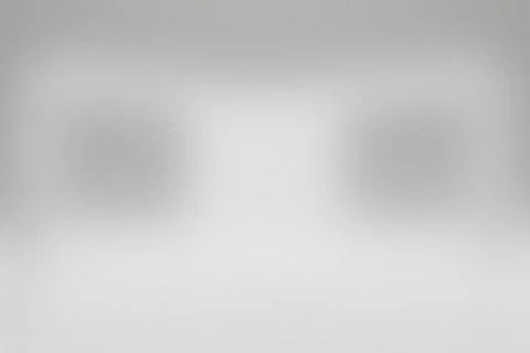 Soft grayscale blur dominates the frame. Two indistinct shapes float agains.. Stock Illustration