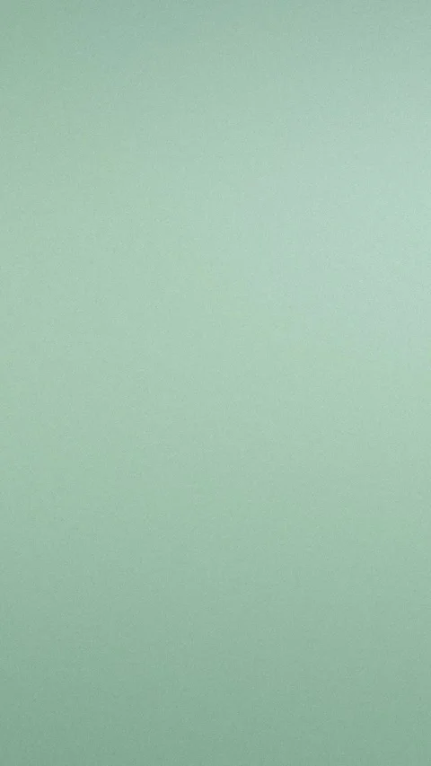 Soft green seamless loop background with a subtle grainy texture. 4K resolution. Stock Footage 309855993