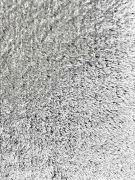 Soft grey plush fabric texture creates a cozy minimalist background for moder 库存照片