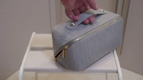 Soft Grey Vanity Case Quickly Drops Onto White Wooden Slats. Stock Footage 321436922