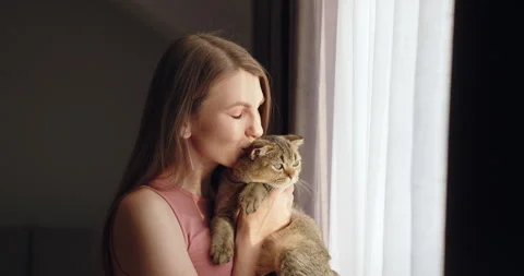 A soft, heartwarming moment captured as a young woman relishes a tender moment Stock Footage 275357189