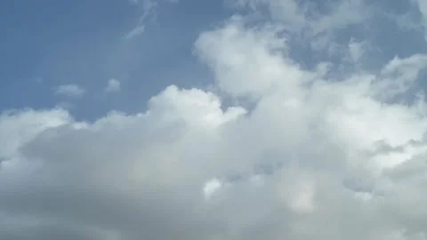 Soft layered clouds flowing across blue sky in timelapse Stock Footage 343069868
