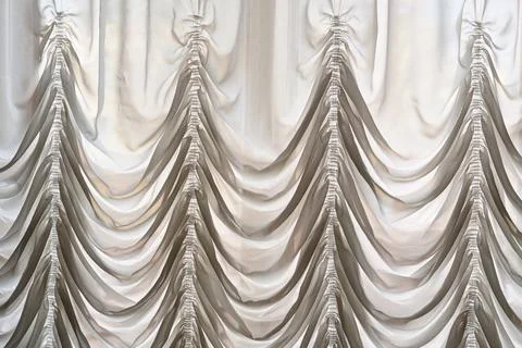 Soft light flows through elegantly ruched white drapery, creating a gentle, Stock Photos