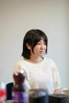 Soft light frames a calm, thoughtful woman 写真素材