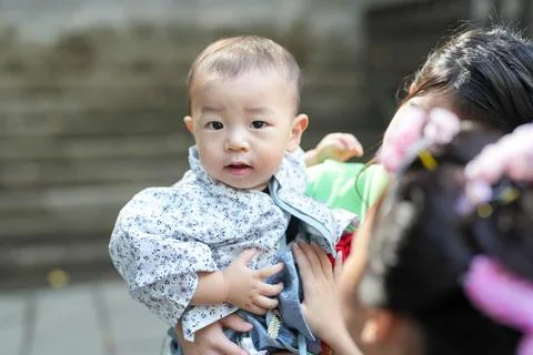 Soft light frames a curious toddler's face 写真素材