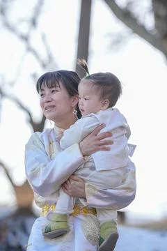 Soft light frames a mother holding her infant 写真素材