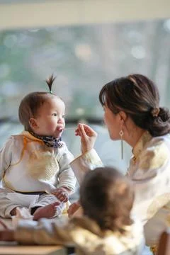 Soft light frames a tender feeding moment 写真素材