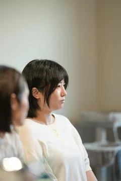 Soft light frames a thoughtful woman in profile 写真素材