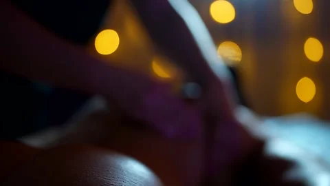 The soft light of the garlands creates a cozy massage atmosphere.   Stock Footage 304115609