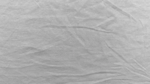 Soft light gray knit fabric texture closeup with gentle wrinkles and ribbed.. Stock Photos