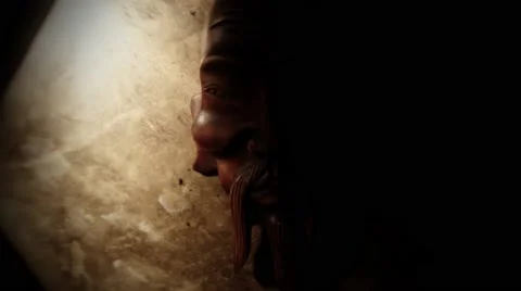 Soft Light Moves on Mongolian Mask in the Dark Closeup Stock Footage 62636089