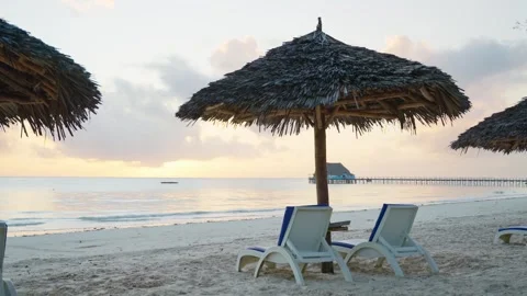 Soft light paints sandy shores with gentle waves Video stock 307718488