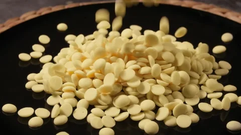 Soft Light White Chocolate Drops Landing on Plate Stock Footage 331298079