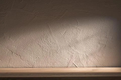 Soft lighting casts shadows on a textured wall, highlighting its details. A r Stock Photos