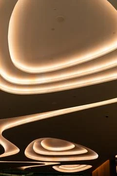 Soft lights on the ceiling create unique shapes in a contemporary space. Th.. Stock Photos