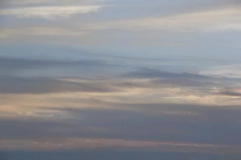 Soft lines of clouds in the sky at sunset Stock Photos