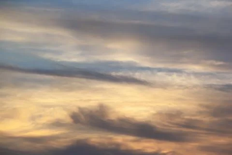 Soft lines of clouds in the sky at sunset Stock Photos