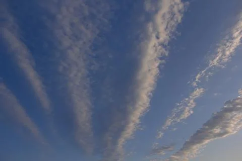 Soft lines of clouds in the sky at sunset Stock Photos