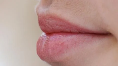 Soft lips close gently against pale skin Stock Photos