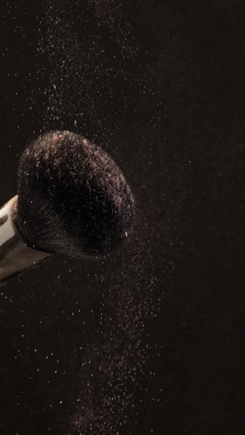Soft makeup brush catching beige highlighter powder in slow motion. Vertica.. Stock Footage 312762646