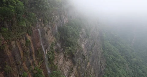 Soft mist drifts through the lush hills of Meghalaya Stock Footage 335646921