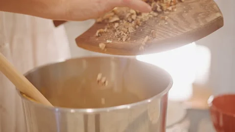 Soft morning light illuminates cozy kitchen while preparing dessert. Gentle hand Stock Footage 346395181